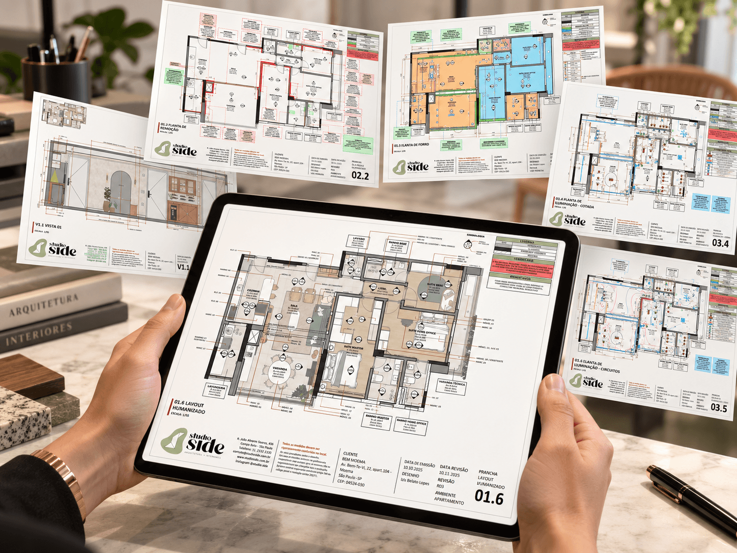 Tablet com a planta de layout humanizado da Studio Side, cercado de pranchas técnicas do projeto executivo