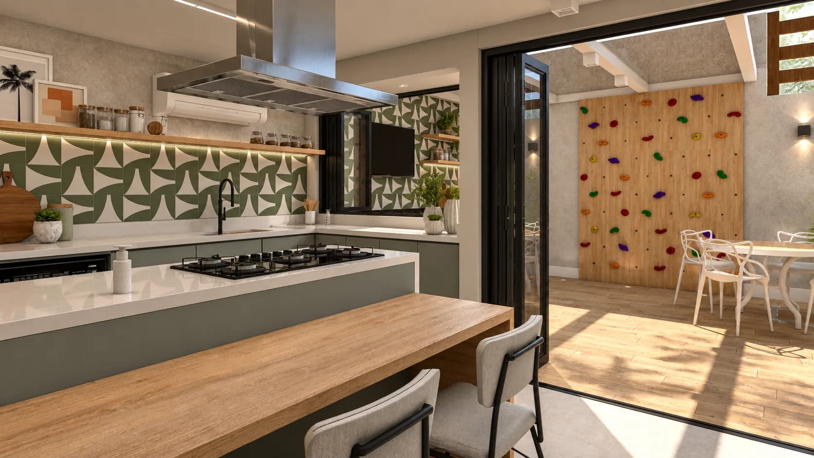 Cozinha com ilha e coifa, aberta para a área gourmet e a parede de escalada